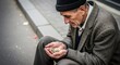 © Margarita Ratatosk - Elder caucasian man counting coins in his hands. Concept of economic hardship, poverty, and financial struggle. For article, report.