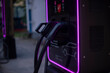 © Ksu - Electric car charging station with a charging cable connected. The station features modern design and illuminated edges, emphasizing sustainable energy use.