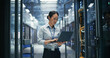 © Gorodenkoff - Asian Female System Administrator Using Laptop Computer for Software Configuration and Data Backup Monitoring While Standing Between Rows of Server Cabinets in AI Cloud Computing Center.