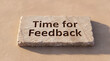 © Emre Akkoyun - Stone slab showing carved text time for feedback, representing a request for evaluation, review, and comment
