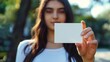 © Sunny_nsk - Young woman holds blank business card