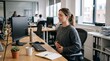 © Mike Ebony - Woman meditating at her office desk to de-stress and find inner peace during a busy workday