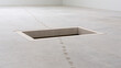 © rohit - Minimalist Concrete Floor with Recessed Opening and Faint Footprints Creating a Sense of Depth and Mystery