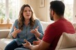 © miss irine - Plus size woman explains something to man sitting on couch in living room. Multiracial couple talks, uses hand gestures during emotional discussion at home. Diverse partners serious conversation in