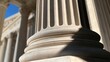 © il - Close-up of a fluted stone column with strong shadows