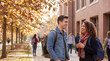 © Morrina - College students are walking and talking on an autumn campus path for back to school marketing