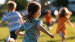 © Laura - rear view of children playing a joyful chase game together in a bright park, backs to camera, active outdoor fun concept, childhood, energy, teamwork, playground, lifestyle,