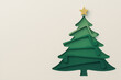 © Chanita - Joyful green Christmas tree shape with yellow star on top, made from layered paper cut. festive holiday decoration with copy space for text. Simple, minimal, and creative
