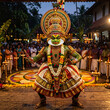 © Tetiana - A Kathakali dancer performing traditional classical art form on stage decorated for Onam festival with musicians and audience in Kerala, India.