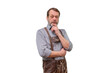 © Anton - Thoughtful senior man in ISOLATED lederhosen costume posing with hand on chin
