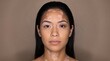 © Haroon - Young woman with vitiligo, close-up portrait with natural skin tone and white patches, looking directly at camera, isolated on a plain brown background, for dermatology and beauty concepts