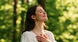 © oksa_studio - Woman in peaceful forest feeling gratitude and mindfulness in serene nature calm