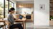 © Vecto_Pixels - Woman sitting at a wooden dining table in a bright kitchen, using a digital tablet to monitor smart home energy consumption and settings