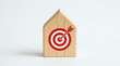 © Dewi Alfi - Wooden House Block With Red Target And Arrow Symbolizing Real Estate Goals, Business Strategy And Success