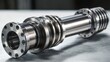 © Milana - polished cylindrical steel shaft with flanged ends, concentric grooves and bolt holes on a work surface conveying precision engineering and industrial strength