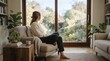 © Mahfuz - Woman sitting in a beige armchair by a large window looking at a green garden in autumn