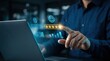 © Funster - Close up of a hand touching glowing digital star rating icons and customer feedback icons on a laptop.