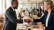 © CH - Diverse business professionals shaking hands in a modern office for a corporate partnership