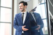 © unikyluckk - Portrait of positive business man looking at camera in modern office. Business consultant meeting is discussing financial situation, analyzing budget and planning business investments. Business