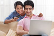 © IndiaPix - Couple using laptop for online shopping