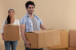 © IndiaPix - Couple carrying cardboard box in room
