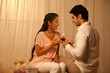 © IndiaPix - Young loving man giving cake to woman at home