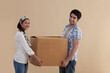 © IndiaPix - Cute young couple holding cardboard box together while moving in