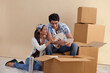 © IndiaPix - Young couple looking at photographs together at home