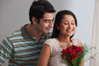 © IndiaPix - Couple spending affectionate time together with a bouquet