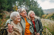 © Halfpoint - Group of mature female friends enjoying countryside walk.