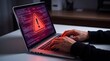 © MDMAHATAB - Person typing on a laptop screen showing a red warning alert sign for cyber security threat and software error
