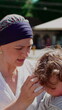 © Marco - Mother embracing toddler during outdoor social gathering, heartwarming family interaction highlighting emotional security, affection, nurturing care and strong parent child bond
