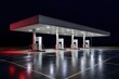 © Bijac - Petrol station forecourt glowing under canopy lights in the rain at night