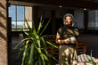 © ADDICTIVE STOCK - Mature woman with coffee in spacious industrial interior