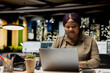© DC Studio - Black female analyst proofreads data reports after hours