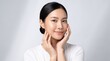 © Being Imaginative - East Asian woman touching jawline, skincare beauty portrait with glowing healthy skin.