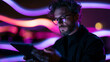 © BlackBridge Media - Focused Professional Man Using Digital Tablet with Futuristic Neon Lights