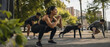 © INsprThDesign - Outdoor fitness group performing bodyweight squat and plank exercises in urban park, with focused adults training together during warm sunny morning session