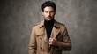© sem.studio - Stylish young man with a confident gaze wearing a sophisticated beige trench coat and black turtleneck against a minimalist grey background, embodying modern elegance and smart fashion