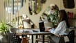 © shine.graphics - Young woman working on laptop at a round table in a modern cafe setting