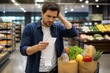 © Formoney - Man checking receipt and comparing prices in supermarket