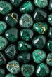© DnQajik - Close-up of assorted green gemstones with golden veins