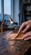 © AdPremium - Artisan hands cutting and skiving genuine leather with a sharp craft knife under warm workshop lighting on a wooden workbench