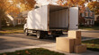 © your picture - Open moving truck parked on a suburban street with cardboard boxes on the curb during an autumn home relocation day