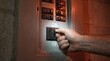 © Tonton1541 - off grid microgrid solution resources efficiency concept. Hand turning on a switch on an electrical control panel with glowing effect