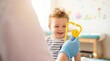 © LK - Smiling Toddler Boy at Pediatric Clinic Visiting Friendly Doctor