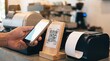 © Dimas Putra Kusumo - Hand scanning QR code for mobile payment at coffee shop counter