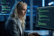 © Maryna - Young blonde female software engineer works on computer code at night. Focused woman programmer types on keyboard in modern dark office. Developer studies data, writes software script on large