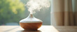 © SUMAIA - Minimalist aroma humidifier with wood base stands on table releasing gentle mist. Functional wellness decor enhances indoor air quality and mood.