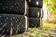 © Travel 'n' Lifestyle - View of a stack of winter tires with metal studs resting on the grass in Riga, Latvia.